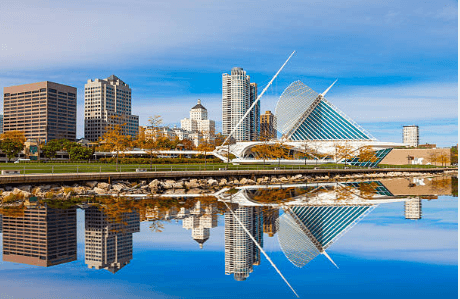 City skyline reflected in calm water.